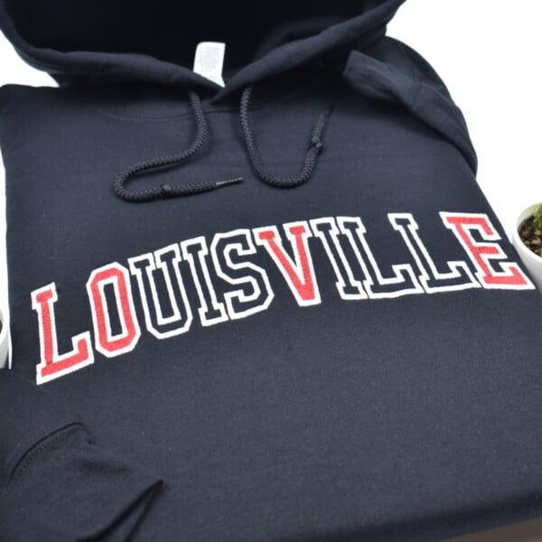 Louisville LOVE embroidered sweatshirt with athletic style text. Louisville Love black hoodie with the white text outline and only the letters LOVE are filled with red.