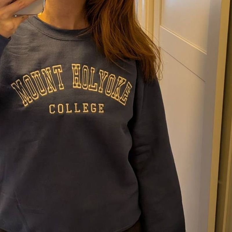 Customer photo: indigo blue sweatshirt embroidered Mount Holyoke College in off-white