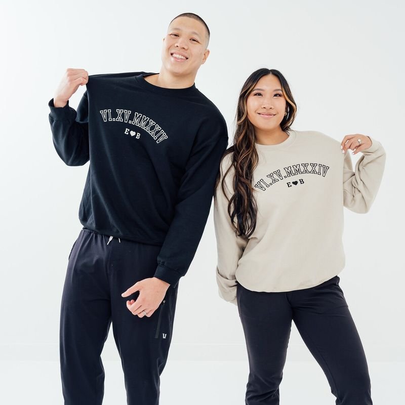 Customer photo: couple in matching black and cream sweatshirts with Roman numeral wedding date