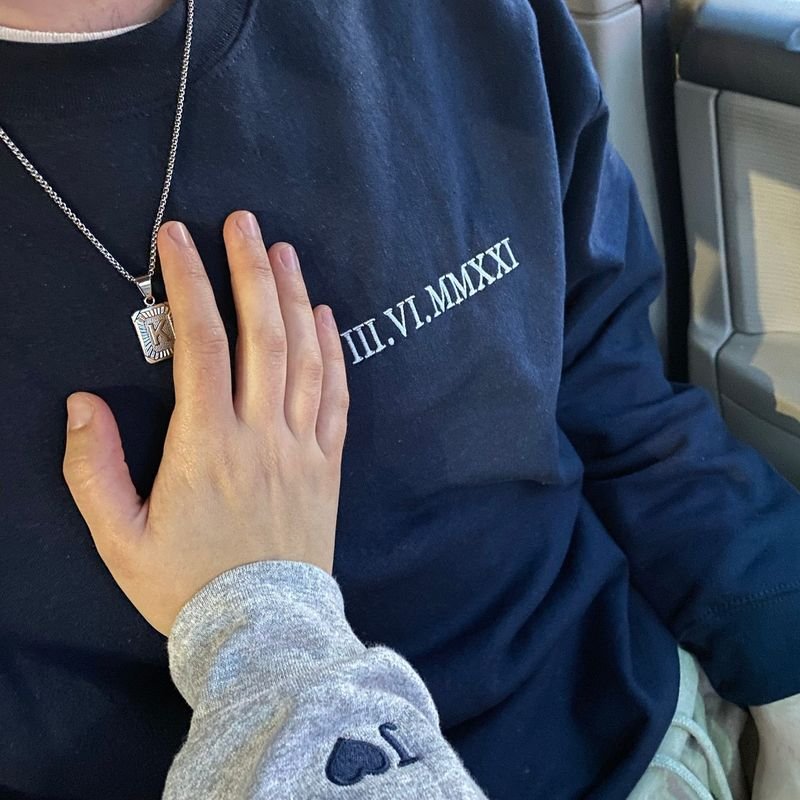 Customer photo: matching couple sweatshirts with Roman numeral date and heart sleeve embroidery